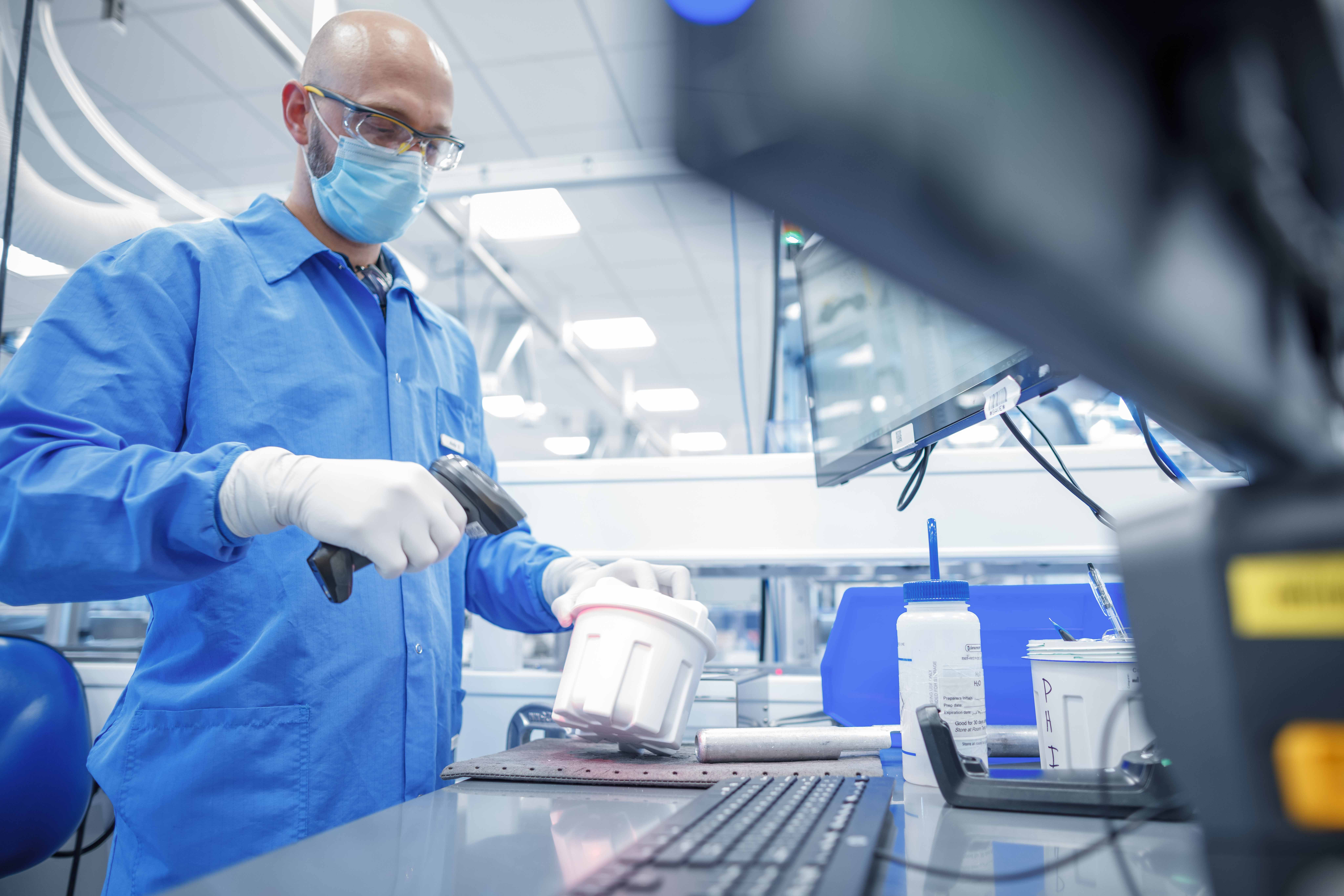 A lab technician processing a Cologuard sample.
